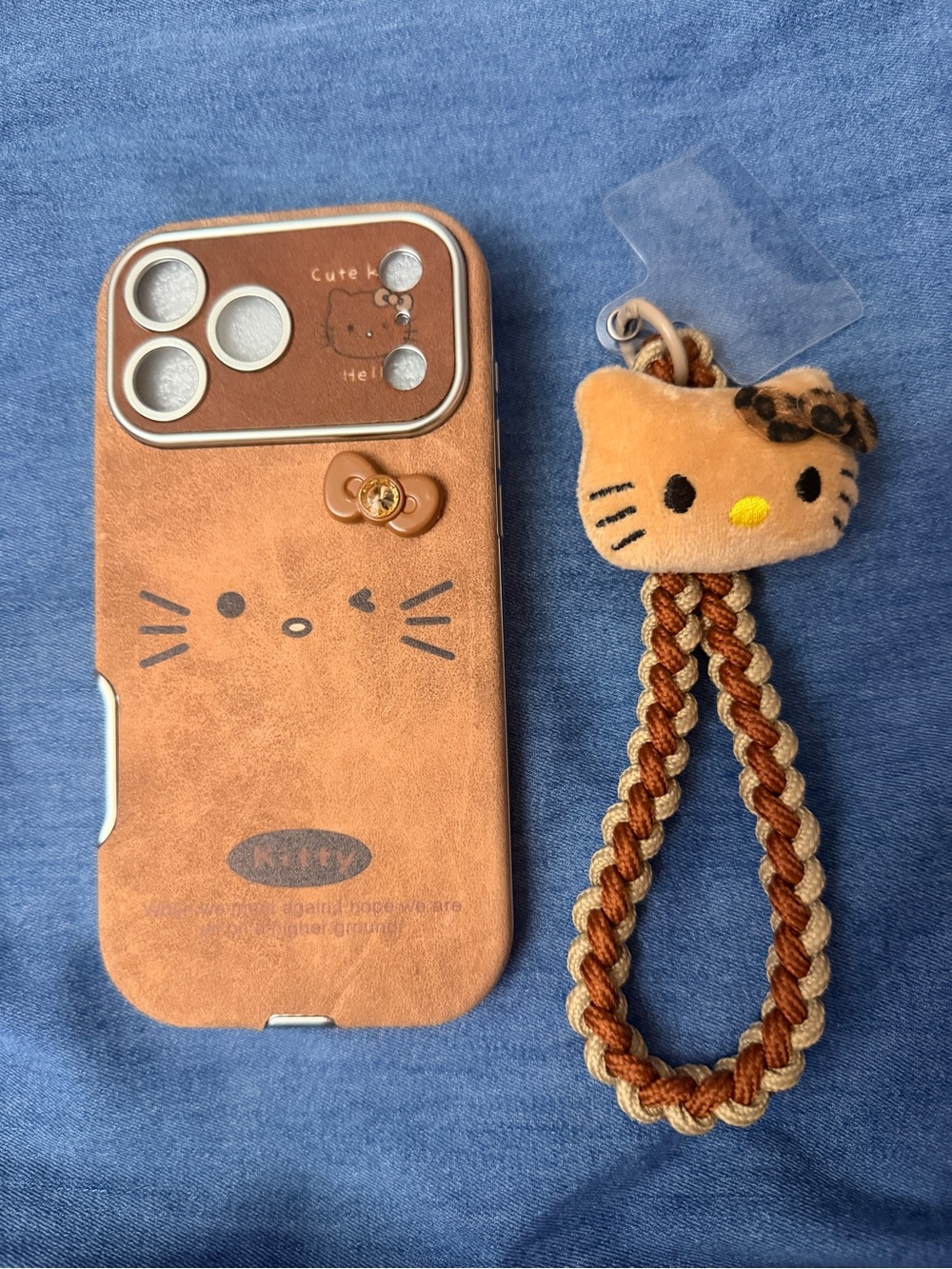 Hello Kitty Brown Faux Leather Phone 16 pro Max Case with Braided Plush Charm